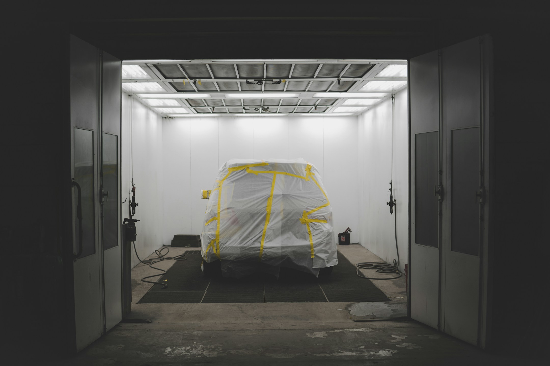 Covered car inside a paint booth